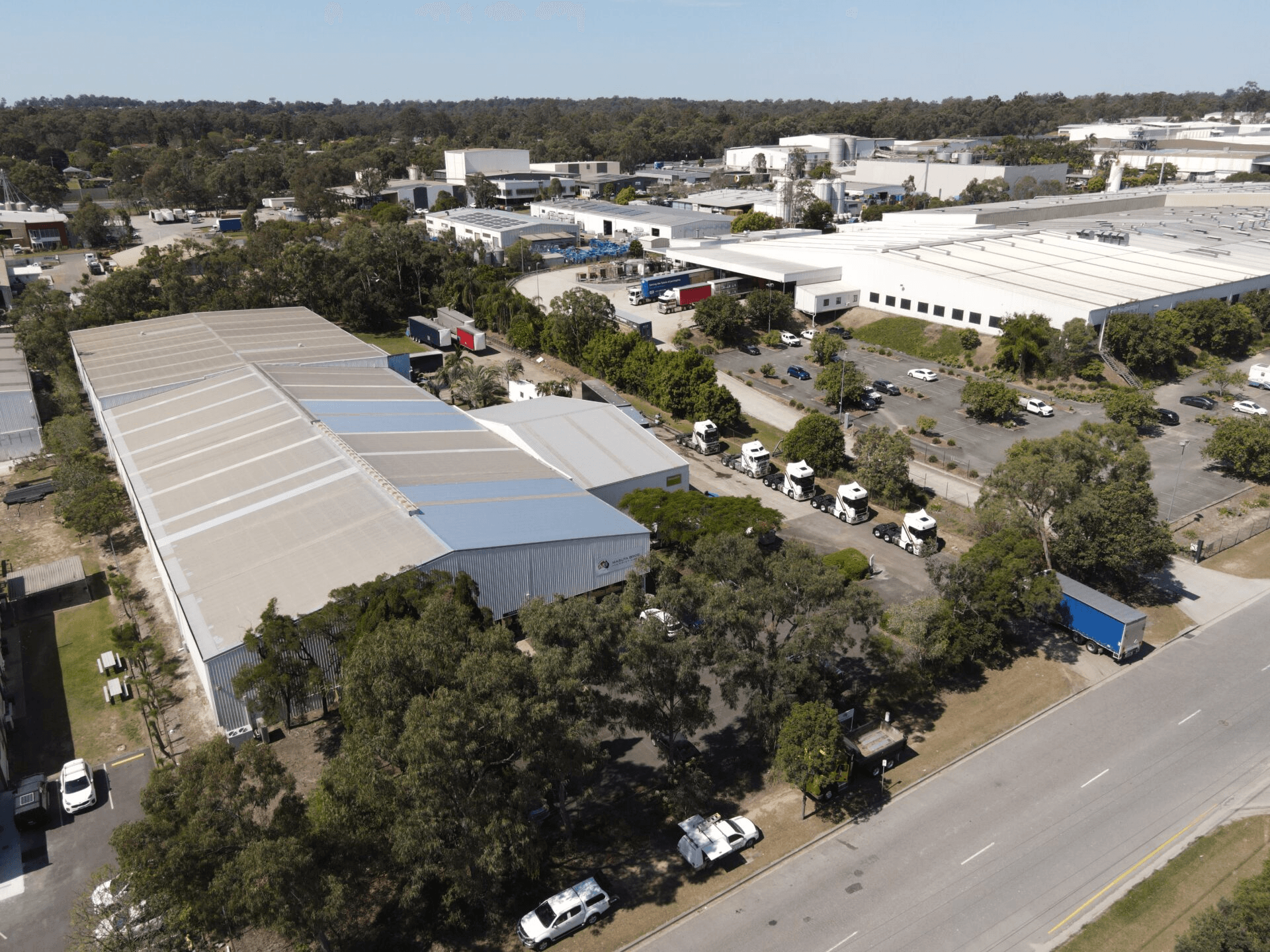 Aerial view of the Masuta Bros warehouse precinct with trucks staged along the loading side